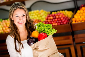 Casual woman grocery shopping and looking happy