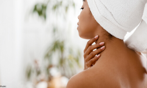 Woman putting on cream for smooth skin